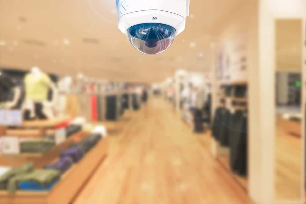 Image is of a surveillance camera inside a retail clothing store, concept of a theft charge and the use of security evidence in criminal cases.