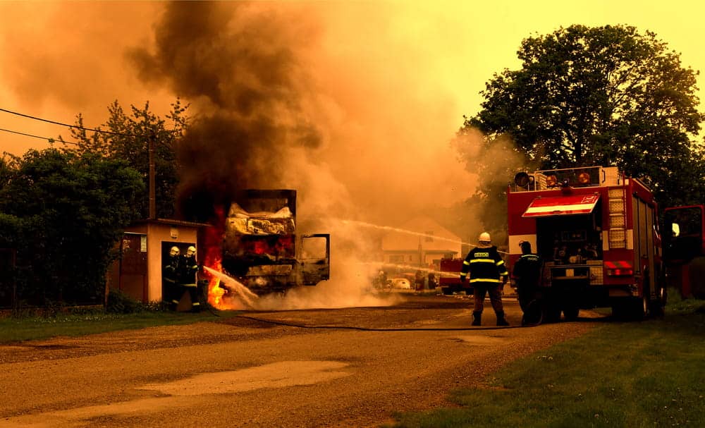 Image is of firefighters responding to an active fire scene, concept of emergency response in an arson lawyer case