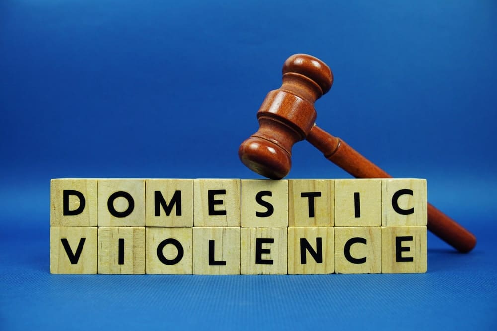 Image is of a gavel placed above blocks spelling domestic violence, concept of domestic violence lawyer