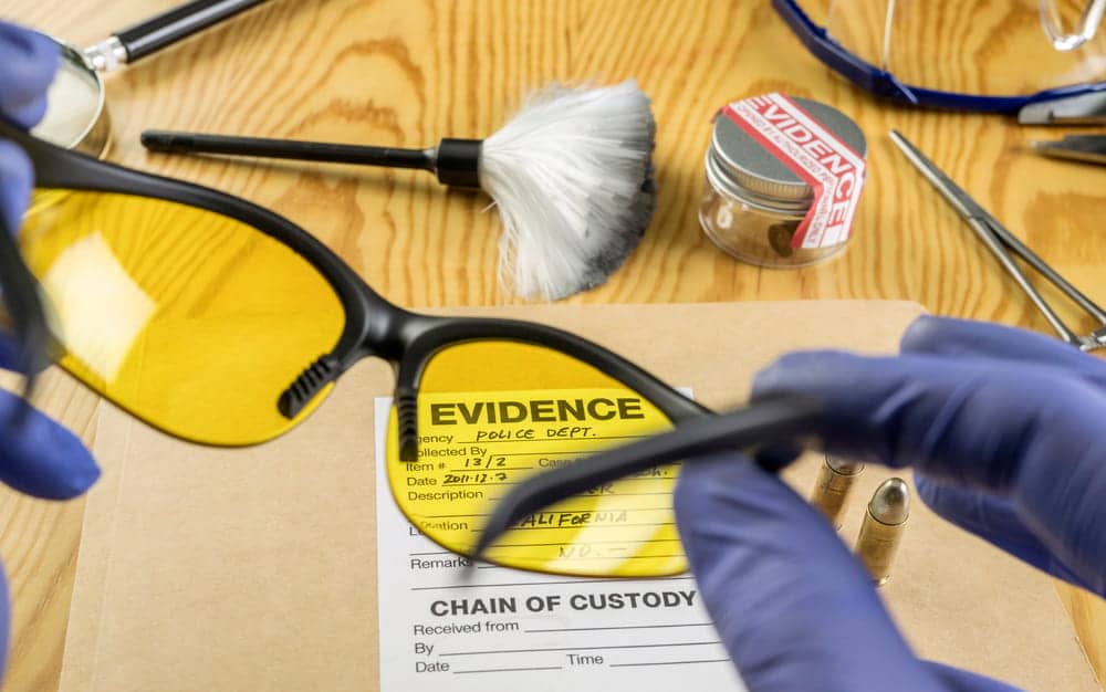 Image is of forensic tools and labeled evidence being examined during investigation, concept of drug crimes lawyer