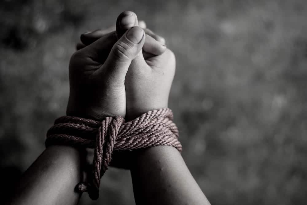 Image is of hands tied together with rope representing restraint, concept of kidnapping lawyer