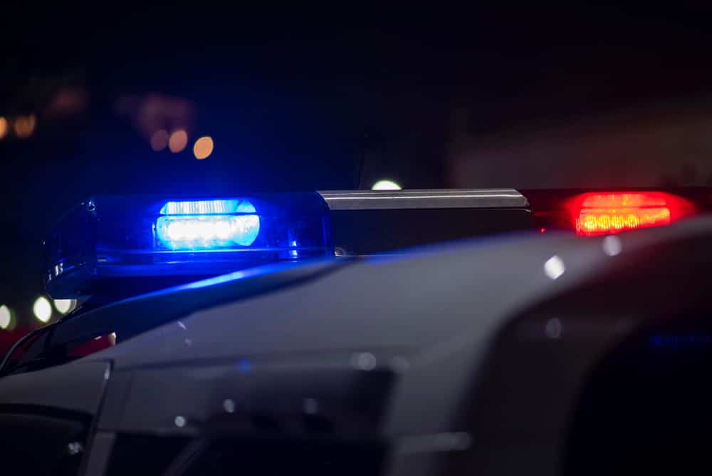 Image is of police lights during a nighttime traffic stop, concept of Knoxville drug crimes lawyer.
