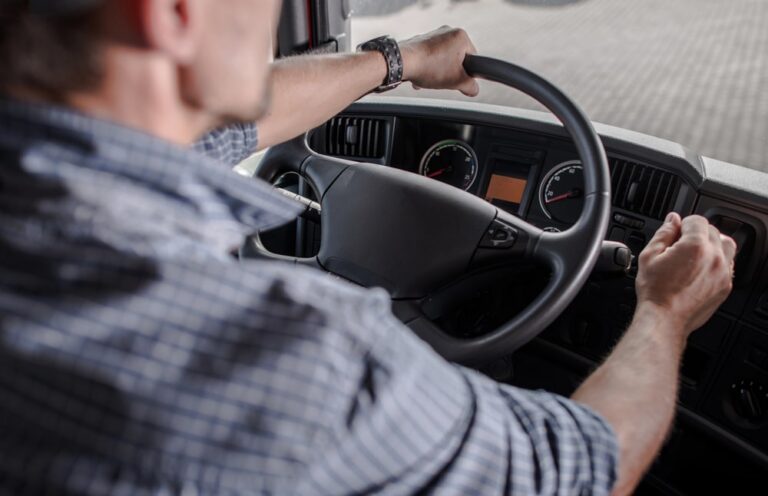 Image is of a commercial truck driver behind the wheel, representing how DUI laws affect CDL holders in Tennessee.