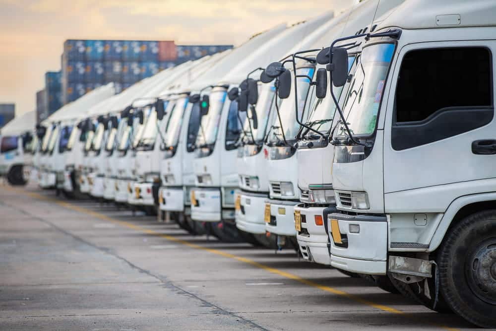 Image is of commercial trucks parked in a fleet yard, concept of how a DUI affect employment in Tennessee driving jobs.