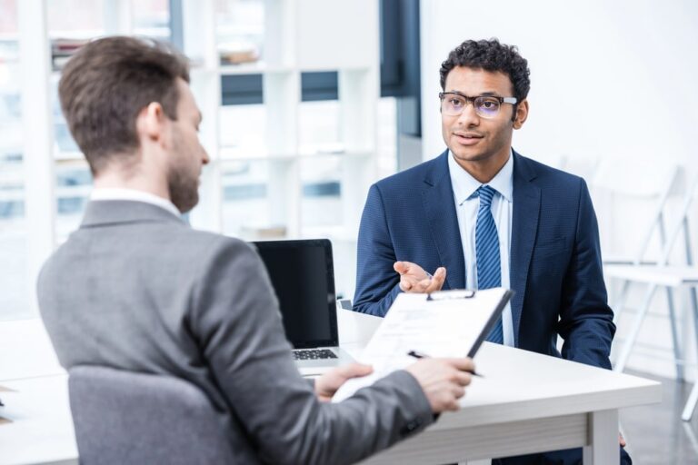 Image is of a job candidate speaking with an interviewer, concept of how a DUI affect employment during the hiring process.