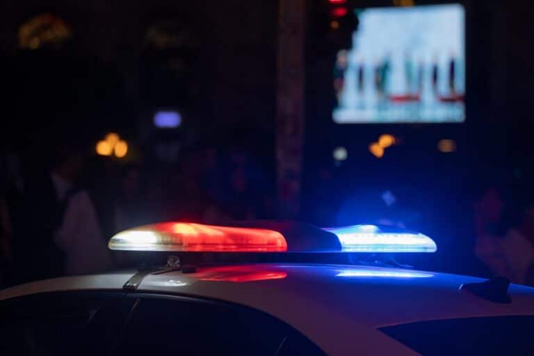 Image is of police lights at night, concept of arrest and legal consequences after an underage DUI in Knoxville